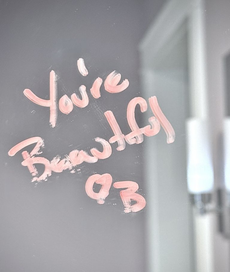 "You're Beautiful" written on a bathroom mirror